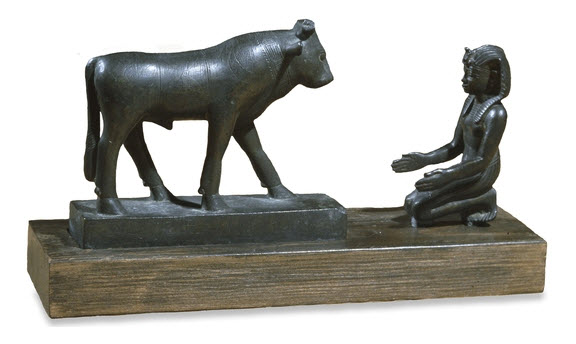 A Pharaoh worships the god Apis like a bull calf